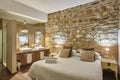 Bedroom with stone walls. Comfortable modern hotel room. Interior Royalty Free Stock Photo