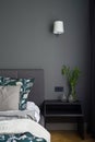 Bedroom with stylish gray wall