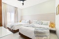 Bedroom with two beds, white comforters, and curtains Royalty Free Stock Photo
