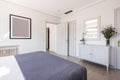 Bedroom of a vacation rental house with white furniture Royalty Free Stock Photo