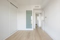 Bedroom with white built-in wardrobe, ducted air conditioning, white wood carpentry, oak-colored Royalty Free Stock Photo