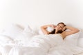 Bedroom - woman waking up and stretching Royalty Free Stock Photo