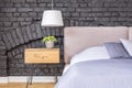 Bedroom with wooden bedside cabinet Royalty Free Stock Photo