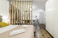 bedroom with wooden lattice delimiting the space between the kitchen Royalty Free Stock Photo