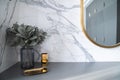 Bedroom working corner decorated with hexagon gold stainless vase and artificial plant in a glass vase on gray spray-painted