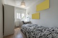 Bedroom with a youth bed, a white desk in a corner, an aluminum window and a large wardrobe