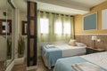 Bedroom with youthful beds with blue bedspreads, green net curtains Royalty Free Stock Photo