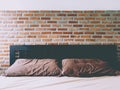 Bedrooms With Exposed Brick Walls Interior Design Ideas.  brick wall behind the bed in red .strong background for an industrial Royalty Free Stock Photo