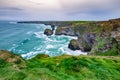 Bedruthan Steps in North Cornwall is a stunning coastline with the waves crashing against the rocks a beautiful landscape Royalty Free Stock Photo