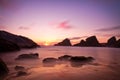 Bedruthan Steps at sunset with violet skies, Cornw