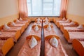 Beds and cots in brightly colored dormitory of a nursery.A lot of children`s cots