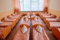 Beds and cots in brightly colored dormitory of a nursery.A lot of children`s cots