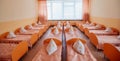 Beds and cots in brightly colored dormitory of a nursery.A lot of children`s cots