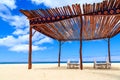 Beds and umbrella on a white sand beach Royalty Free Stock Photo