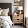 Bedside cabinet next to bed: rustic cabinet next to bed with beige pillows farmhouse interior design of contemporary bedroom Royalty Free Stock Photo