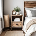 Bedside cabinet next to bed: rustic cabinet next to bed with beige pillows farmhouse interior design of contemporary bedroom Royalty Free Stock Photo