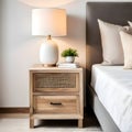 Bedside cabinet next to bed: rustic cabinet next to bed with beige pillows farmhouse interior design of contemporary bedroom Royalty Free Stock Photo