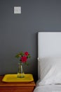 Bedside table with a rose and a tray