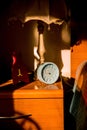 Bedstand with lamp and clock, time concept Royalty Free Stock Photo
