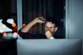 Bedtime is calling. a young businessman feeling exhausted while working at his desk during a late night at work. Royalty Free Stock Photo