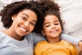 Afro Mother And Daughter Lying In Bed In Bedroom, Top-View