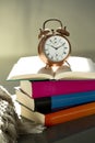 Bedtime reading, alarm clock and books Royalty Free Stock Photo