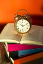 Bedtime reading, alarm clock and books Royalty Free Stock Photo