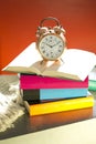 Bedtime reading, alarm clock and books Royalty Free Stock Photo