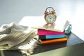 Bedtime reading, alarm clock and books Royalty Free Stock Photo
