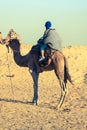 Beduins leading tourists on camels at short tourist tour around