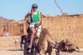 Beduins and tourits ride a camels in the desert