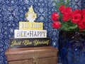 BEE (be) kind, Bee (Be) happy, and just BEe yourself - inspirational sign with yellow gnome