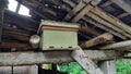 bee box on the roof of the wooden cowshed