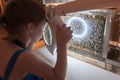 Bee Museum in Pastida Village. Greece. 30/05/2018. 6 years old girl is learning about secret life of bees through magnifying glass Royalty Free Stock Photo