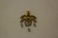 The bee pendant: the famous gold ornament from Malia is a pectoral pendant consisting of two bees depositing a drop of honey in Royalty Free Stock Photo