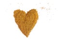 Bee pollen yellow granules crumbled in the shape of heart Royalty Free Stock Photo