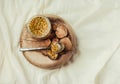 bee pollen in a jar on a wooden stand, white linen tablecloth.Copy space.Top view.