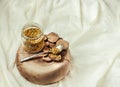 bee pollen in a jar on a wooden stand, white linen tablecloth.Place for text.Selective focus.