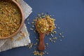 Bee pollen in a wooden spoon healthy food supplements. Close up on a black background. Top view, flat lay. copy space Royalty Free Stock Photo