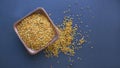 Bee pollen in a wooden spoon healthy food supplements. Close up on a black background. Top view, flat lay. copy space Royalty Free Stock Photo