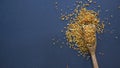 Bee pollen in a wooden spoon healthy food supplements. Close up on a black background. Top view, flat lay. copy space Royalty Free Stock Photo