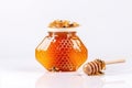 A bee sits on a honeycomb - a jar of honey white background