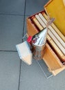 Bee smoker and deep honey beehive frames Royalty Free Stock Photo