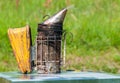 Bee smoker is a beekeeping tool for making smoke used to calm bees.