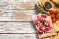 Beef bacon, marbled meat strips on a cutting board. White wooden background. Top view. Copy space