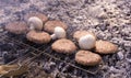 Beef BBQ Cooking of burger meat and mushroom. Iron barbeque grill pan with fire and food. Hamburgers outdoors barbecuing on coals. Royalty Free Stock Photo