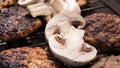 Beef BBQ Cooking of burger meat and mushroom. Iron barbeque grill pan with fire and food. Hamburgers outdoors barbecuing on coals. Royalty Free Stock Photo