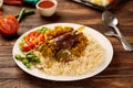 Beef biryani with pickle, salad and tomato sauce served in a dish isolated on wooden table background side view of fastfood Royalty Free Stock Photo