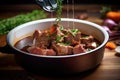 beef bourguignon being ladled onto a plate from a pot Royalty Free Stock Photo