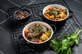 Beef bourguignon meat stew with vegetables, mushrooms and red wine in a pot. Black background. Top view Royalty Free Stock Photo